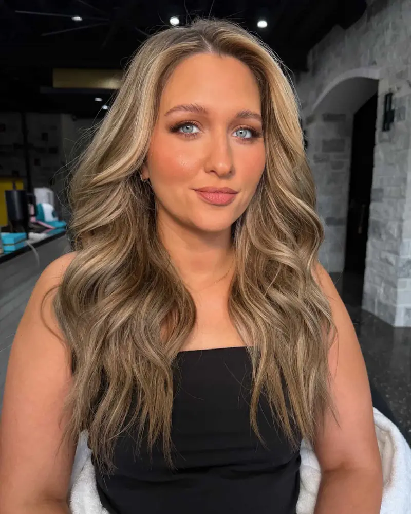 Kacie McBee smiling, with long wavy blonde hair
